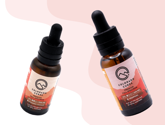 Colorado Cures CBD oil tincture bottles with droppers against pink gradient background